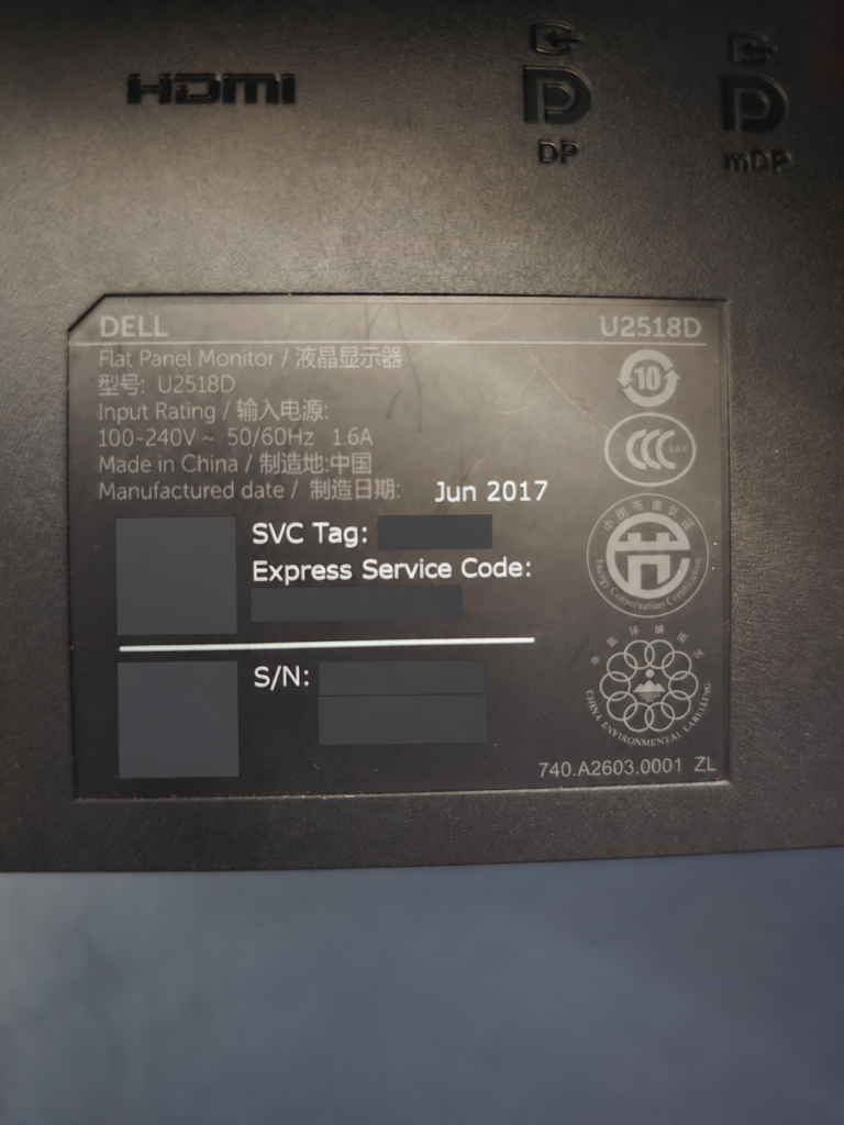 Dell U2518D monitor model and connection details, with identifying codes obscured